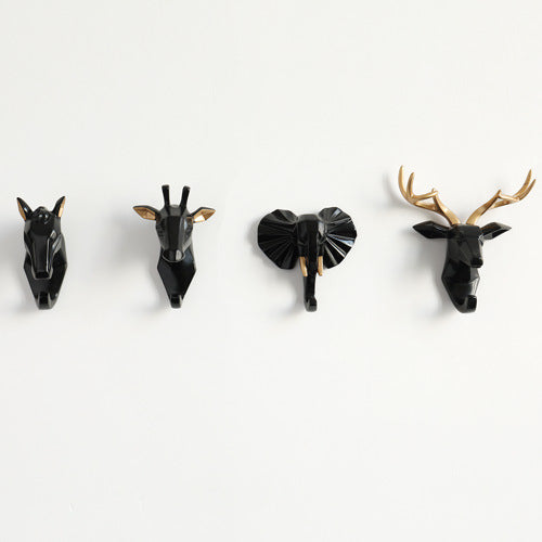Belro animal head wall hook resembling a bear, mounted on a wall, used for hanging robes and clothing in bedroom decor.