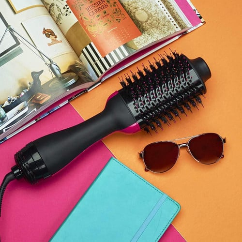 Belro blow-drying volumizer brush for hair, showing a close-up of the brush with bristles and handle in a hair care setting.