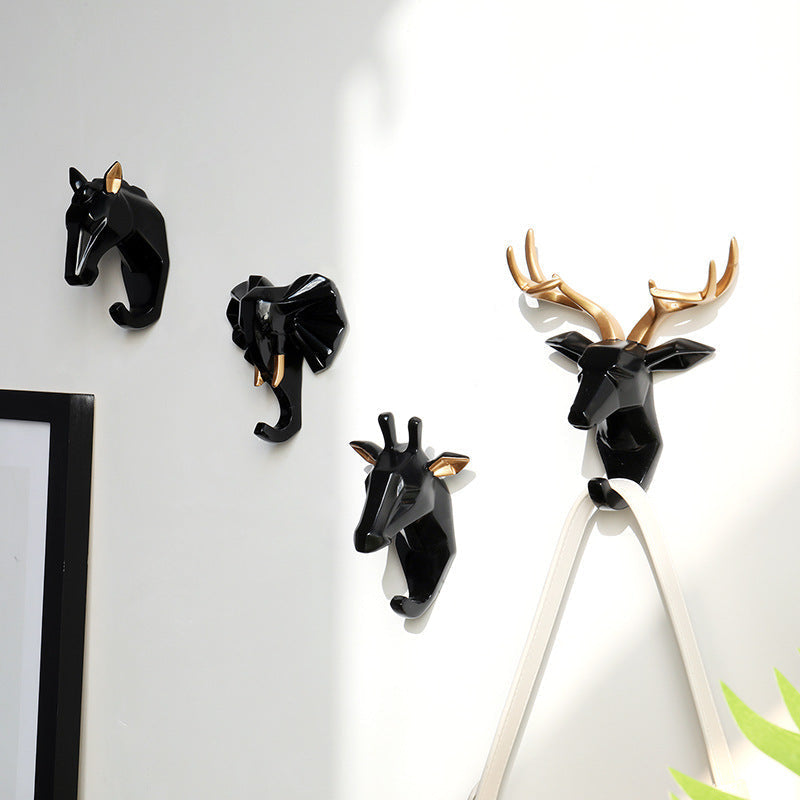Belro animal head wall hook mounted on a wooden wall, ideal for hanging robes and clothing in a stylish bedroom decor.