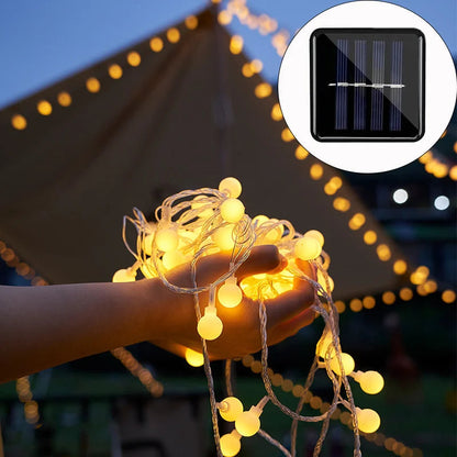 Belro solar-powered fairy lights for outdoor use, string of decorative LED lights illuminating garden or patio space.