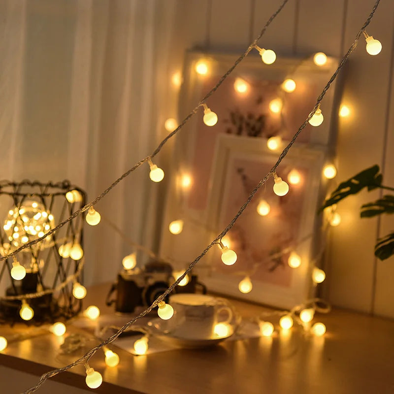 Belro solar-powered fairy lights for outdoor use, string of small decorative LED lights illuminating a garden setting.