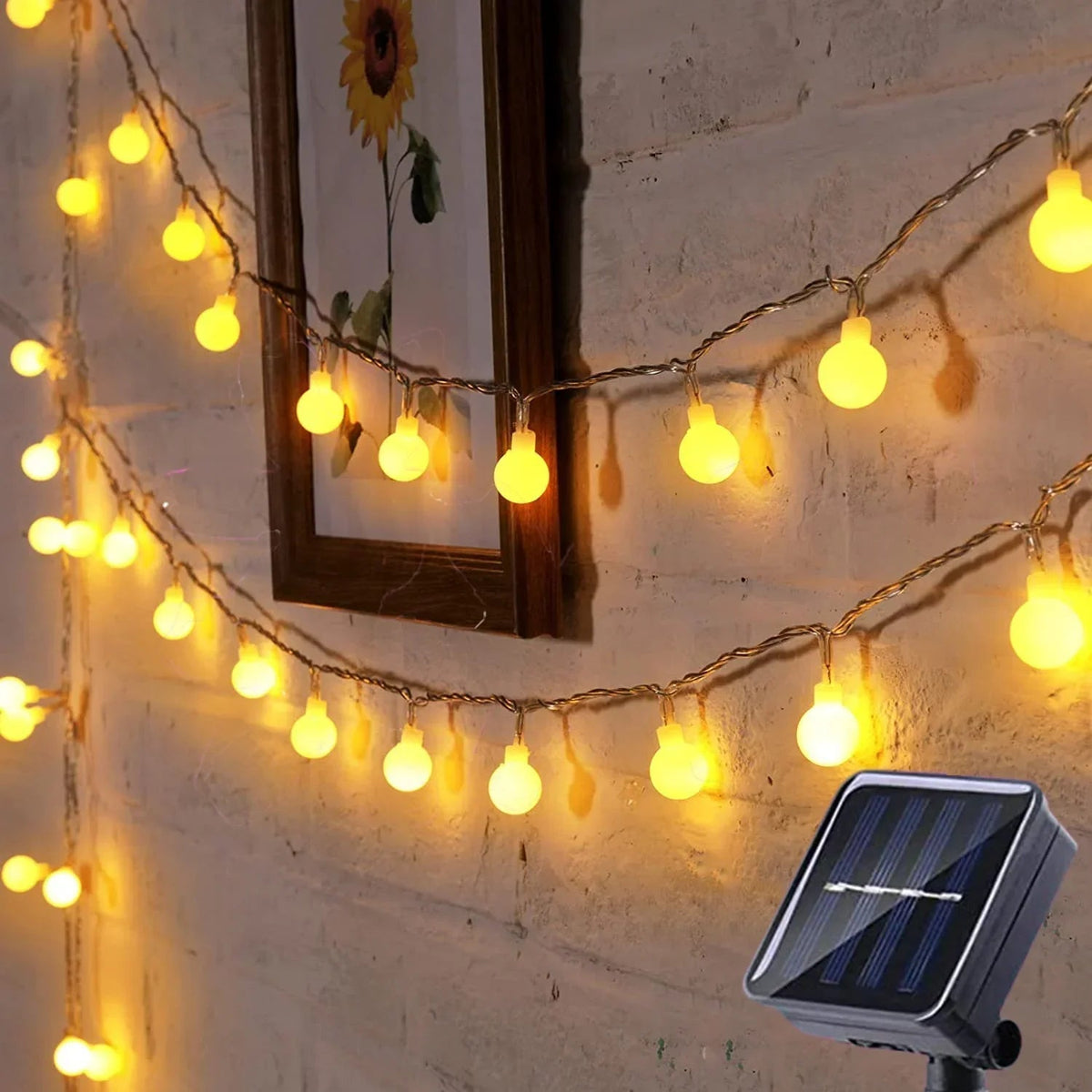 Belro solar-powered fairy lights for outdoor use, string of small glowing LED bulbs decorating a garden or patio area.