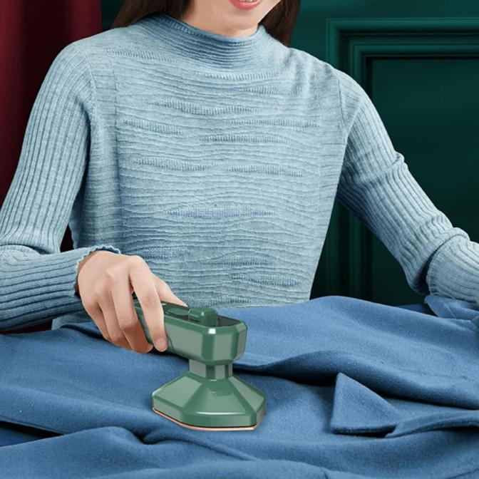 Mini portable iron by Belro for outdoor use, compact design suitable for travel and quick clothing touch-ups.