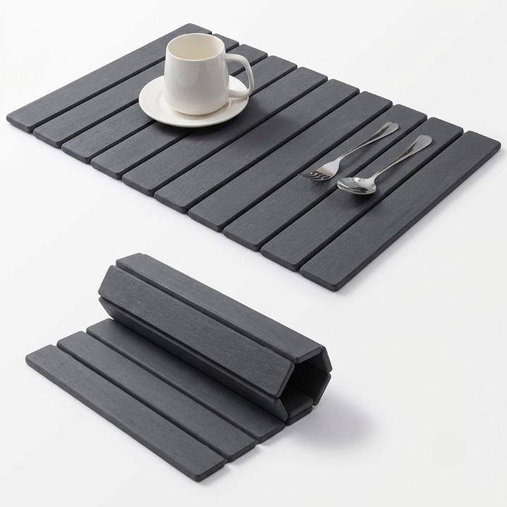 Mivoza diatomite stone dish drying mat, super absorbent and foldable, laid out on kitchen countertop for drying dishes.