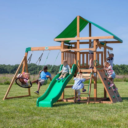 Backyard Discovery Grayson Peak swing set by Casavibeo featuring slide, swings, and climbing elements in a backyard setting.