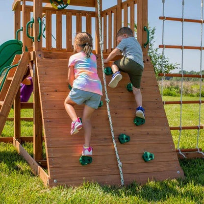 Casavibeo Backyard Discovery Grayson Peak Swing Set with rock wall and climbing features in a backyard setting.
