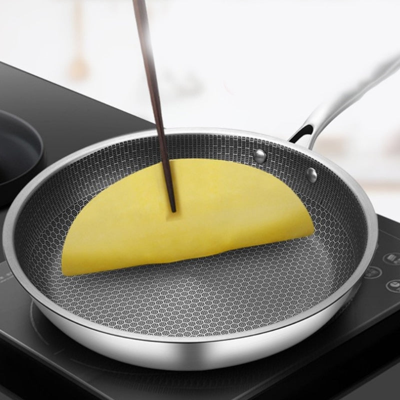 Belro non-stick stainless steel frying pan with a black handle, shown on a kitchen countertop, ideal for versatile cooking.