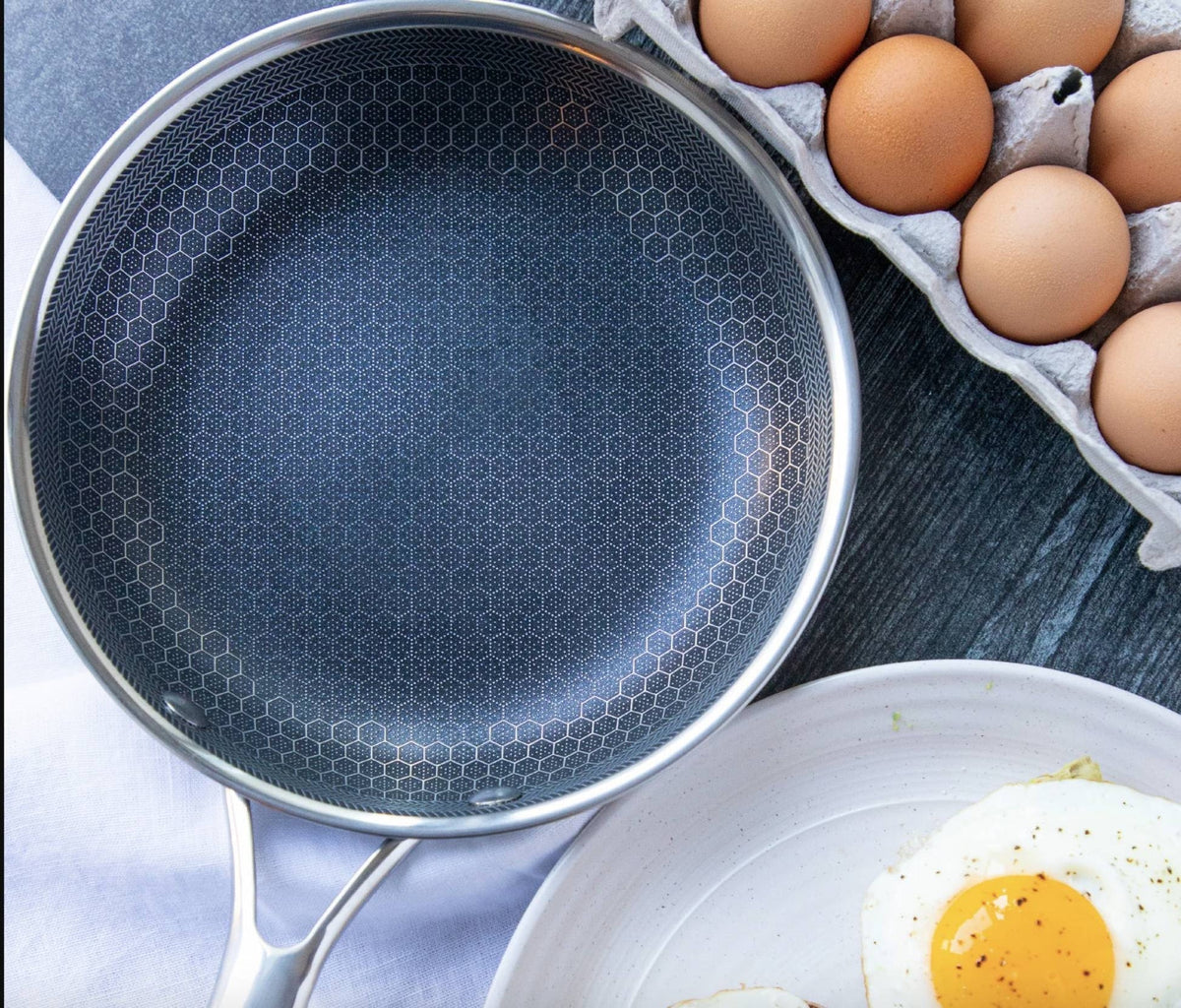Belro non-stick stainless steel frying pan with black handle, shown on stovetop, ideal for versatile kitchen cooking.