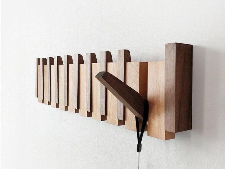 Handmade wooden coat rack with multiple hooks for jackets and coats, crafted by Belro, ideal for entryways and closets.