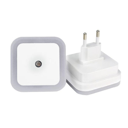 Belro plug-in motion detector smart outlet night light connected to an electrical outlet in a home setting.