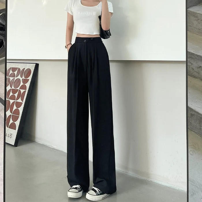 Belro pleated trousers, stylish and comfortable clothing with tailored pleats, shown hanging on a white background.