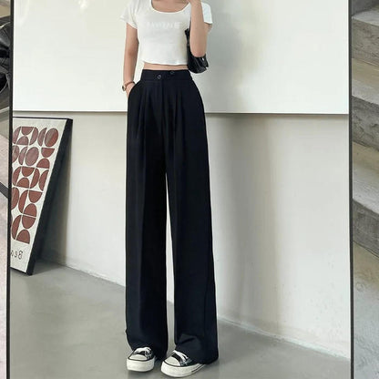 Belro pleated trousers, stylish and comfortable clothing with tailored pleats, shown hanging on a white background.