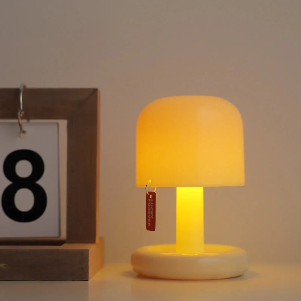 Belro Mini Sunset Light illuminating a cozy bedside table with warm, ambient sunset-inspired glow.