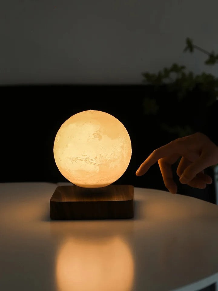 Belro floating moon lamp illuminated in a dark room, showcasing its realistic moon design and soft glowing light.