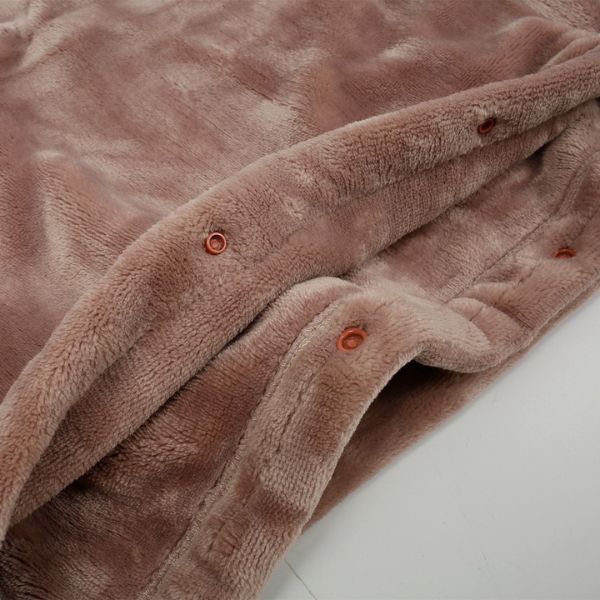 Belro cordless electric heated blanket spread on a bed, showcasing its soft fabric and control button for cozy warmth.