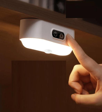 Belro LED motion detector nightlight illuminating a dark hallway with a sleek white design and motion sensor.
