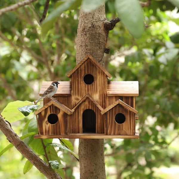 Handcrafted wooden birdhouse with six entrance holes, designed for outdoor garden decor by Belro.