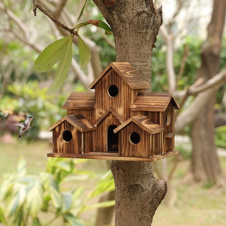 Handcrafted wooden birdhouse with six entry holes, decorative garden decor by Belro for outdoor bird nesting.