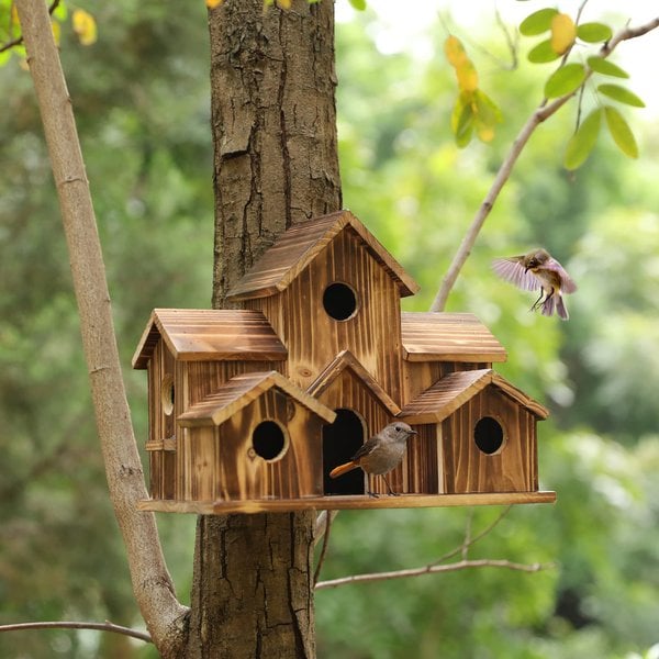Handcrafted wooden birdhouse with six entrances from Belro, designed for outdoor garden decor, featuring natural wood finish and roof.