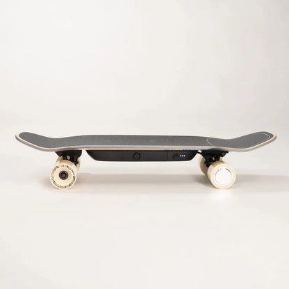 Casavibeo Liquid Skateboard LQS-1 with black deck, silver trucks, and white wheels, shown from the left side.