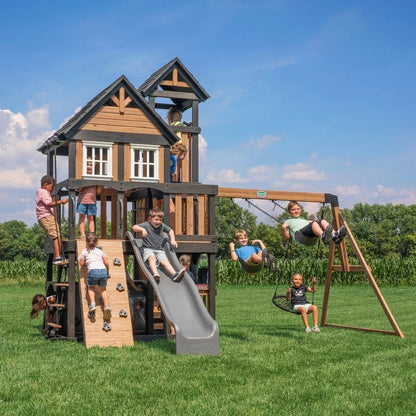 Casavibeo Mystic Tower Swing Set in backyard with climbing tower, slide, and swing, perfect for outdoor play for kids.