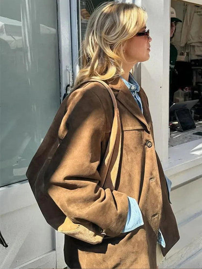 Belro brown single-breasted jacket displayed on a hanger, showcasing its classic fit and tailored design.