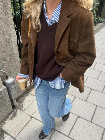 Belro brown single-breasted jacket hanging on a wooden hanger, showcasing its classic design and tailored fit.