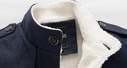 Belro classic wool trench coat hanging on a wooden rack, showcasing its tailored design and neutral color.