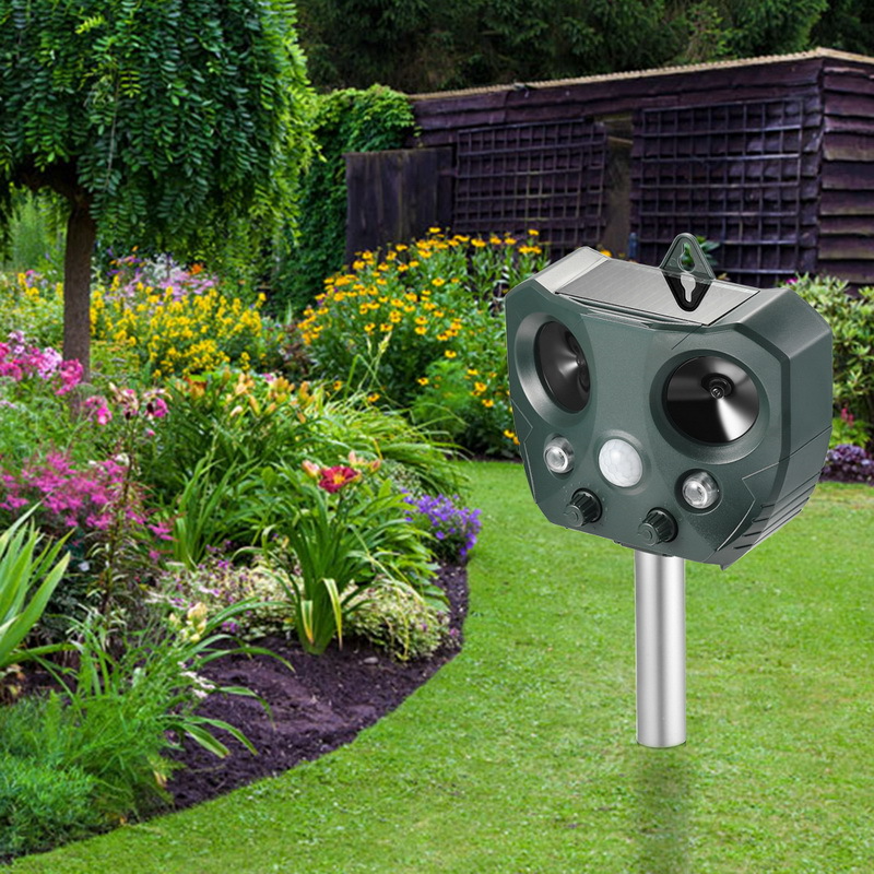 Belro Solar Ultrasonic Animal Repeller in outdoor garden setting, showing device with solar panel and pest control features