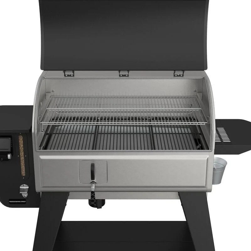 Open view of the Camp Chef Woodwind Pro 36 Pellet Grill showing its stainless steel exterior, control panel, and cooking grates.