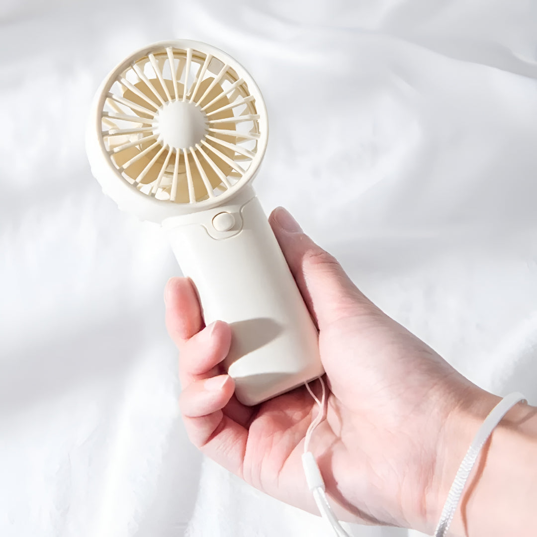 DecorsDeluxe ZenWave Traveler portable mini handheld fan with battery, compact design, ideal for travel and on-the-go cooling.