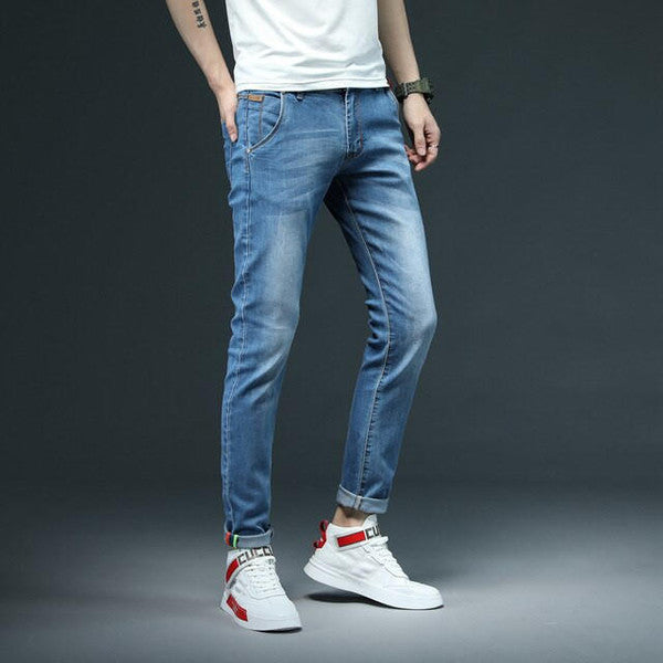 Pair of slim fit Belro denim jeans with a classic five-pocket design, shown on a hanger against a neutral background.