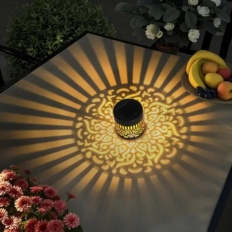 Mivoza solar decorative lantern with shadow pattern, weatherproof IP65 garden lighting, illuminated during nighttime.