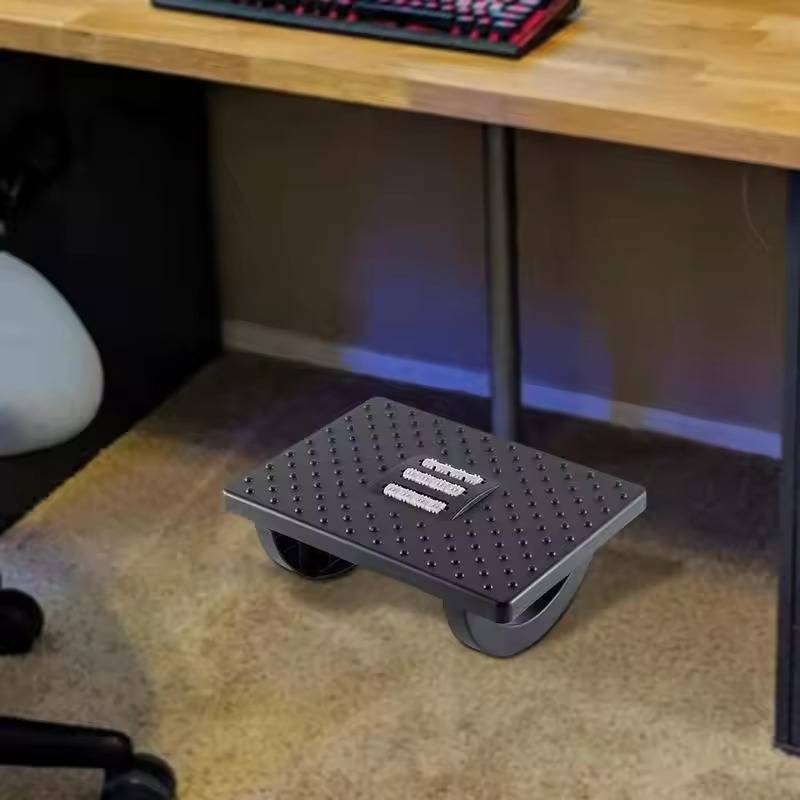 Belro under desk foot rest accessory, ergonomic support for comfortable sitting, shown on a desk setup.