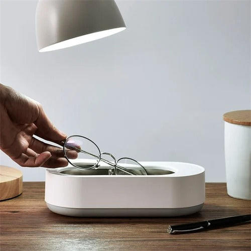 Portable ultrasonic cleaner from Belro for jewelry cleaning, compact device with stainless steel basin and ultrasonic technology.