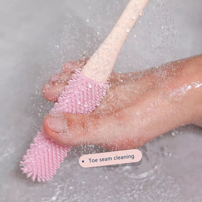 Gray Belro Toe Gap Cleaning Brush with long handle and silicone foot scrubber for effective foot hygiene and exfoliation.