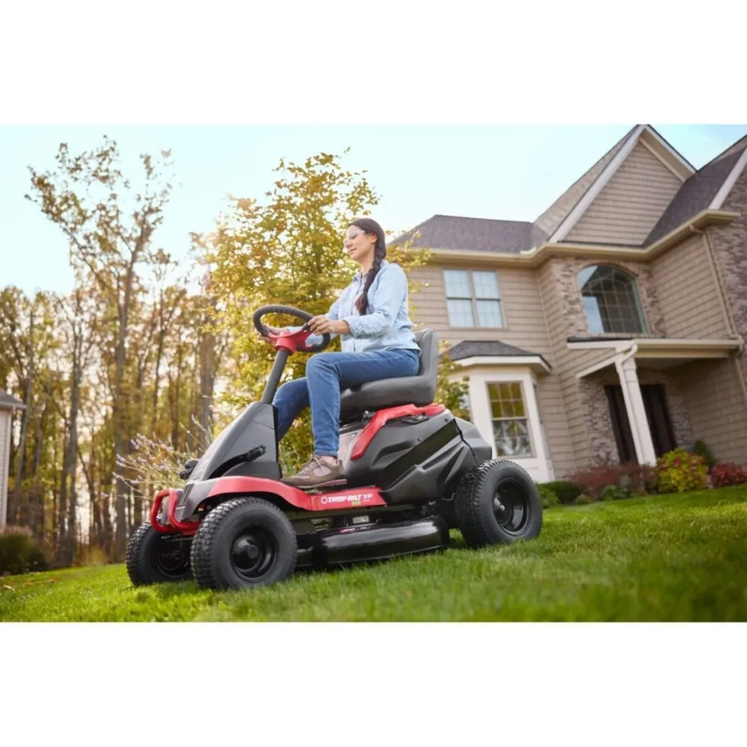 Casavibeo Troy-Bilt TB30E XP 30-inch electric lawn mower with 56-volt lithium-ion battery and cordless design, shown in a backyard setting.