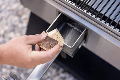 Casavibeo Camp Chef Woodwind Pro 36 Pellet Grill with stainless steel lid and control panel, set outdoors with grilling accessories.