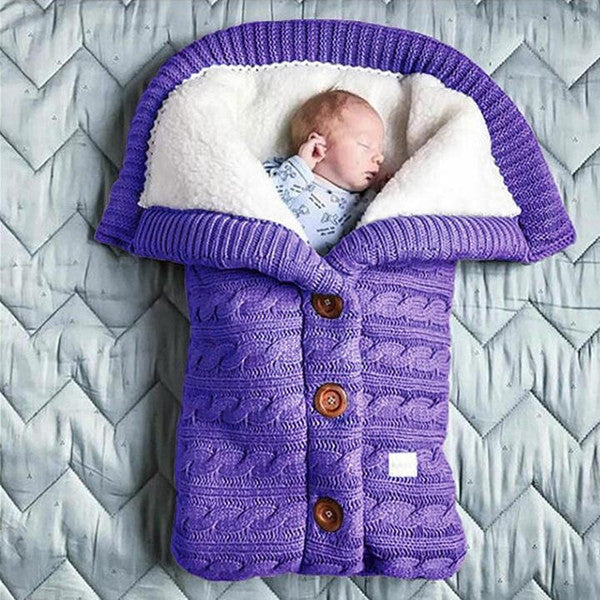 Soft Belro baby blanket in cozy fabric, shown draped on a bed, ideal for newborns and infants.