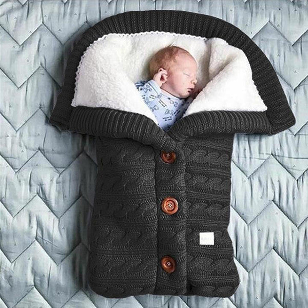 Soft Belro baby blanket in cozy fabric, perfect for nursery or stroller, shown draped on a bed with gentle pastel colors.