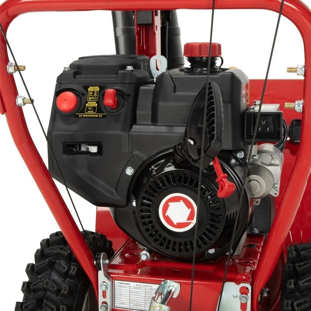 Casavibeo Troy-Bilt Storm 24-inch two-stage gas snow blower with large clearing width and durable augers in action.