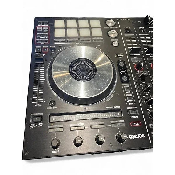 Used Pioneer DJ DDJSX2 DJ controller with jog wheels, mixer, and controls, shown in a casual setup.