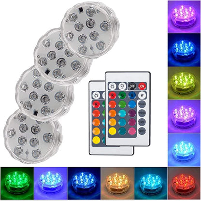 Set of four Belro submersible LED pool lights in a backyard pool, illuminating the water with vibrant colors.