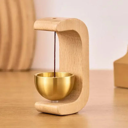 Wireless door chime with brass bell and wooden frame from Belro, showcasing its classic design and modern smart home functionality.