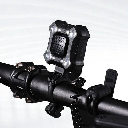 Belro bike bell and light mounted on a bicycle handlebar, outdoor setting, showcasing the product's compact design and functionality.