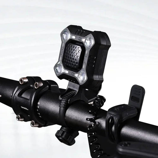 Belro bike bell and light mounted on a bicycle handlebar, outdoor setting, showcasing the product's compact design and functionality.