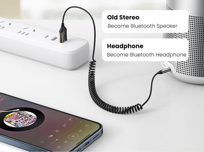 Belro Bluetooth Aux Adapter connected to an audio device, compact electronics for wireless audio streaming.