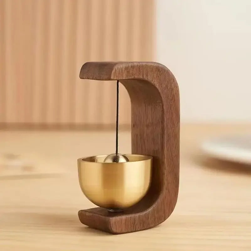 Wireless door chime with brass bell and wooden frame from Belro, featuring a sleek, modern design for smart home doorbell systems.