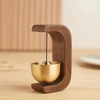 Wireless door chime with brass bell and wooden frame from Belro, featuring a sleek, modern design for smart home doorbell systems.