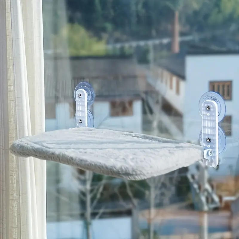 Belro cat hammock window mounted on a home window sill, providing a cozy resting spot for cats with a soft fabric surface and suction cups.